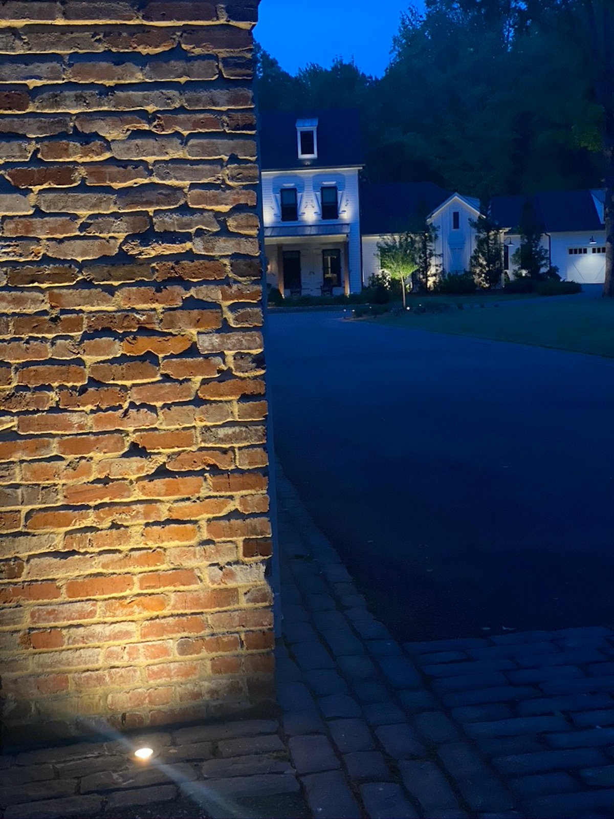 uplighting on brick wall with house in background