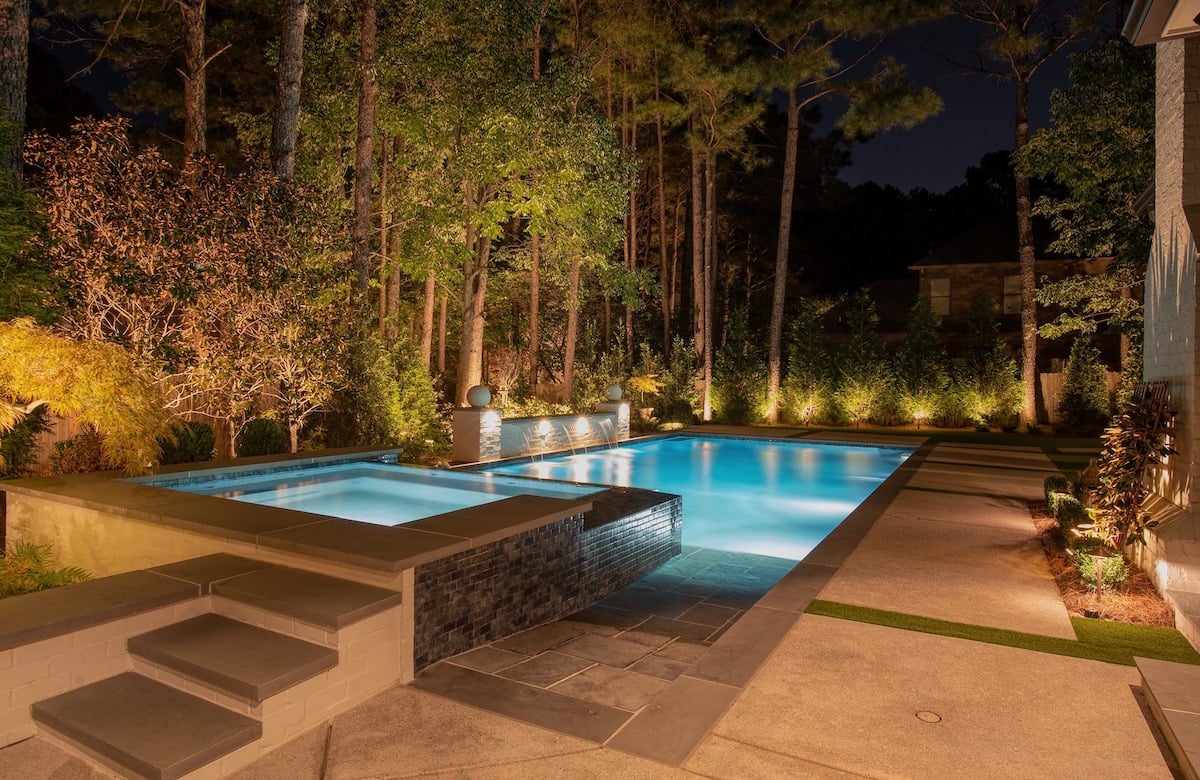 Pool and trees with landscape lights